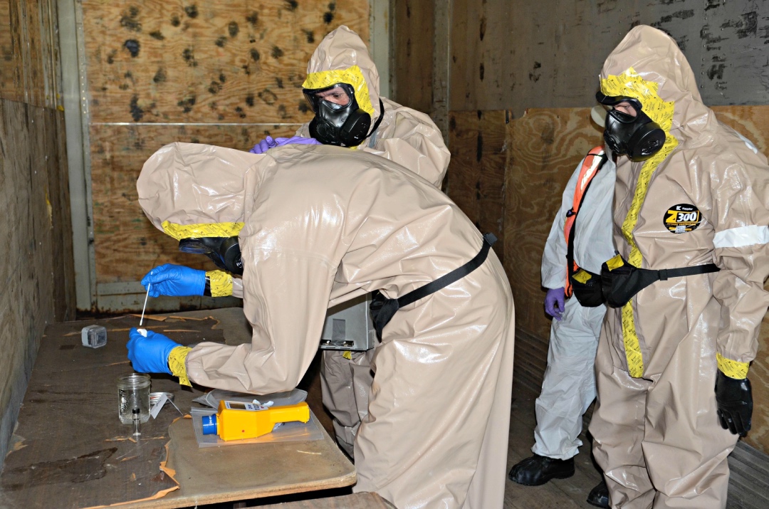 NATO forces participate in a decontamination scenario during Exercise Precise Response at CFB Suffield in Canada. (DND/MDN Canada).