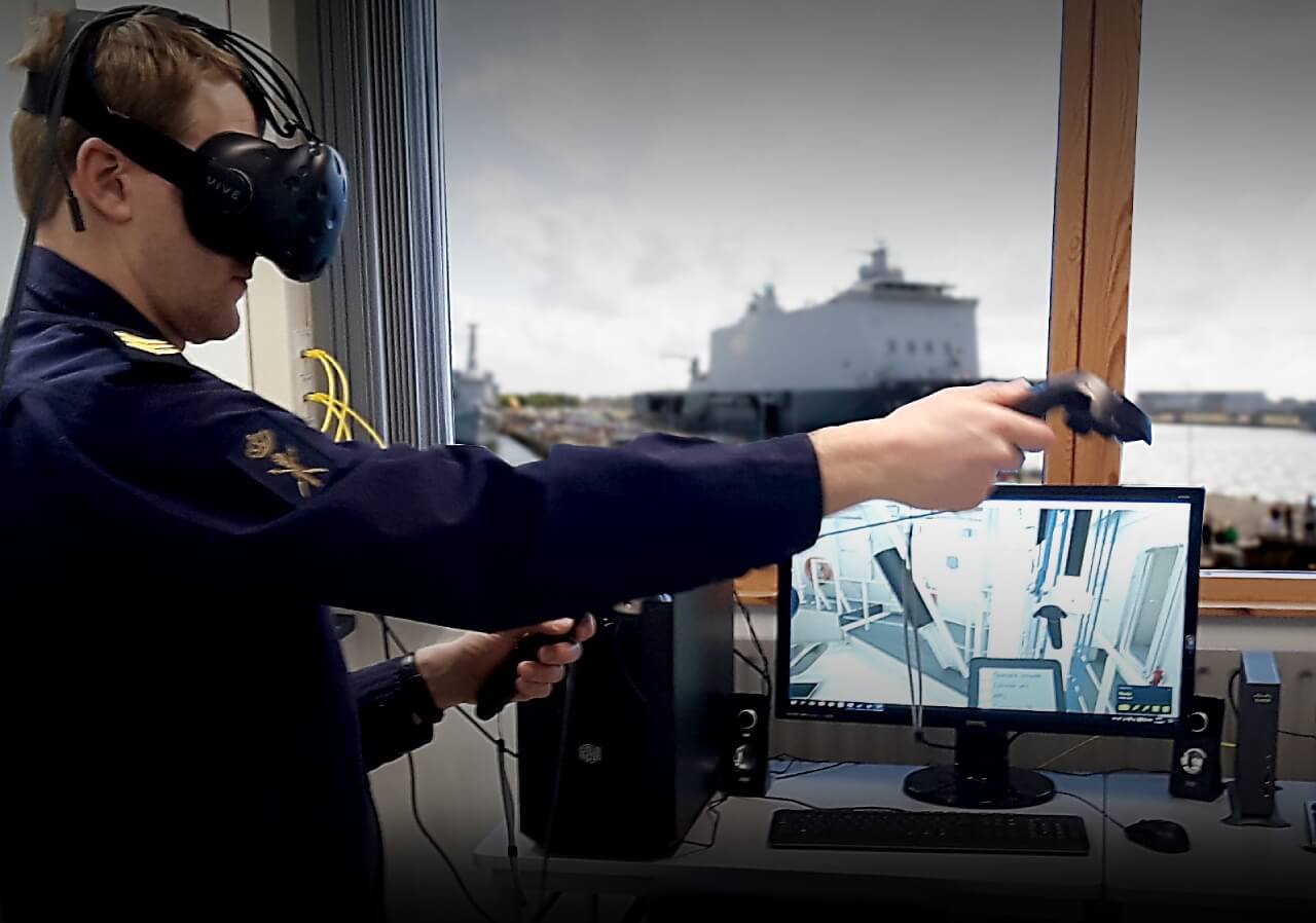 An RNLN Maritime Simulation Centre staff member demonstrates use of an operator training VR set up, which is designed to show operators how to use certain systems.