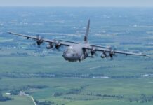 The US military focuses on Venezuela High-altitude military transport aircraft landing on runway surrounded by forest, showcasing advanced aviation technology and defense capabilities.